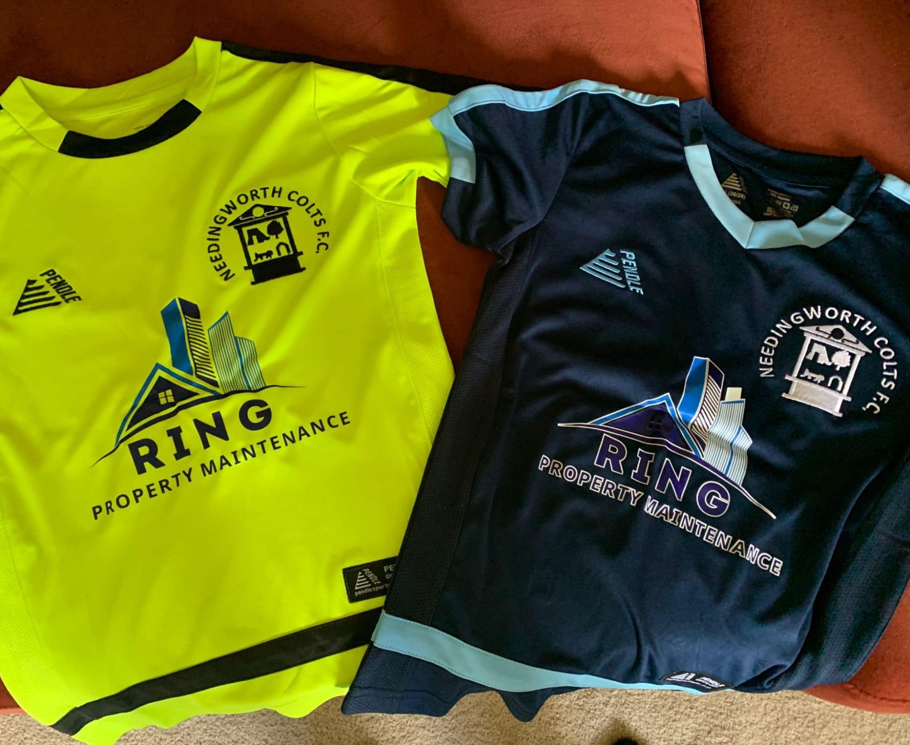 Two football shirts: one yellow, one navy, both with a logo and "RING" branding.