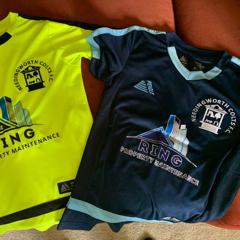 Two football shirts: one yellow with black logos, one navy blue with white accents.